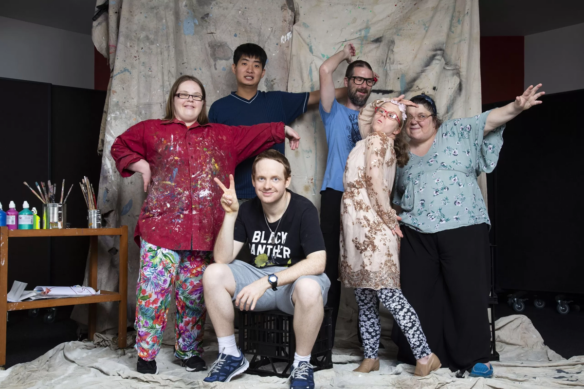 Group of Studio A artists posing together in a studio space.